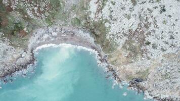 Foamy turquoise sea washing shore surrounded by rocky cliff. Cantabria, Spain photo