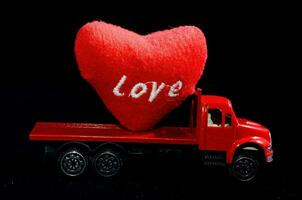 a red truck with a heart on the back photo