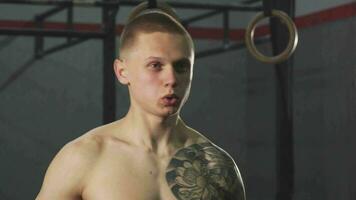 Young tattooed crossfit athlete exercising with a kettlebell video