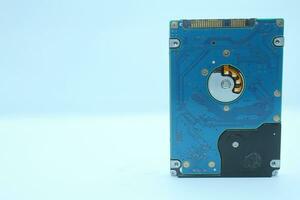 Hard disk drive on blue background, closeup of computer disk drive photo