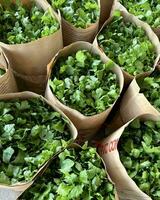 Fresh green leafy vegetables are available for sale photo