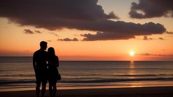 silhouette of a couple on the beach at sunset. photo