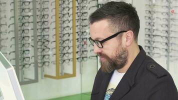 Professional optometrist working on a computer at his shop video