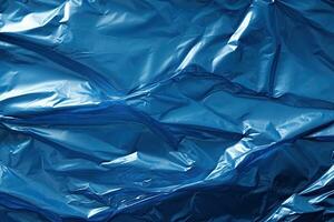 blue plastic wrap overlay backdrop. crumpled and draped textured cellophane material photo