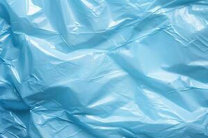 bright blue plastic wrap overlay backdrop. crumpled and draped textured cellophane material photo