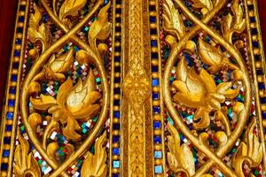 golden door with intricate designs and flowers photo