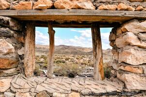 an old window in a stone building in the desert photo