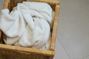 Dirty cloth towels in wooden box in bathroom, household chore photo