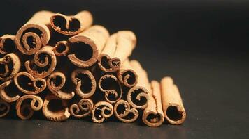 Cinnamon sticks on a black background video