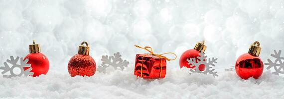 Christmas decorations red toys balls on the snow sparkling silver background banner wish copy space photo