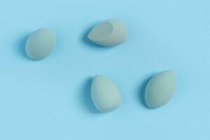 Blue cosmetic makeup sponge on a minimal background. Tool for applying foundation cream. Nobody photo