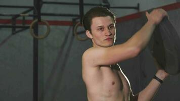 Shirtless young sportsman concentrating exercising with weights video