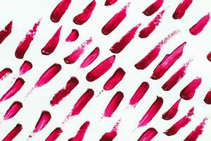 Smears of red cosmetic lipstick on a light background photo