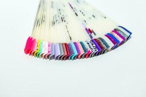 Palette of nail designs, testers of multicolored polishes on flat nails photo