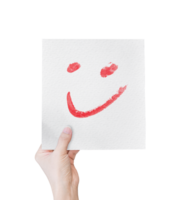 Hand holding white paper with hand drawn smiley face emoticons isolated on transparent background. PNG Format