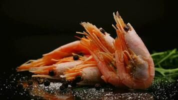 boiled shrimp with spices on black background video