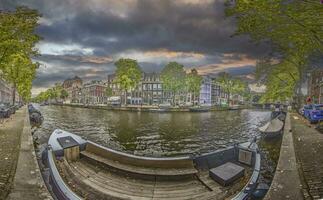 View over a typical canal in the Dutch metropolis Amsterdam in summer 2023 photo