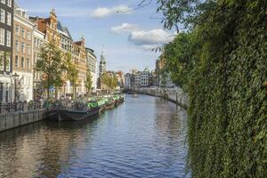 View over a typical canal in the Dutch metropolis Amsterdam in summer 2023 photo