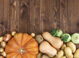 Harvest on wooden table background, top view photo