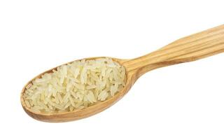 Parboiled rice in spoon on white background photo