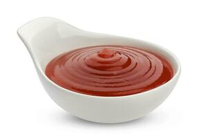 Sauceboat of ketchup isolated on white photo