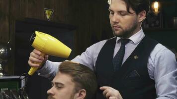 Young handsome man getting his hair dried by a barber video