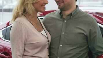 Cropepd shot of a happy couple holding car keys to a newly bought car video