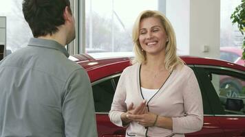 Gorgeous happy mature woman receiving car keys from her loving husband video