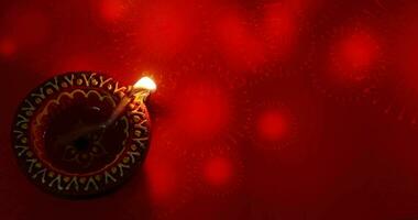 Oil lamp burning with fireworks on red background. Diwali celebration, Deepam festival video