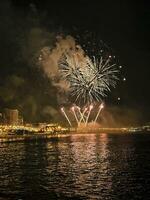 colorful fireworks in the night sky on the seafront of Alicante spain photo