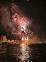 colorful fireworks in the night sky on the seafront of Alicante spain photo