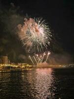 colorful fireworks in the night sky on the seafront of Alicante spain photo