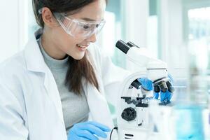 Scientist analyze biochemical samples in advanced scientific laboratory. Medical professional use microscope look microbiological developmental of viral. Biotechnology research in science lab. photo