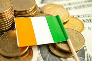 Stack of coins with Ireland flag and US dollar banknotes. photo