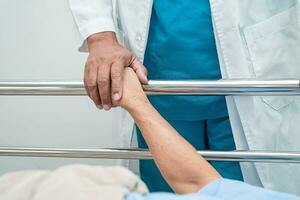 Doctor checking senior patient woman lie down on a bed in the hospital, healthy strong medical concept. photo