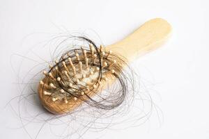 Hair loss fall with comb bush serious problem health, beauty and cosmetic concept. photo