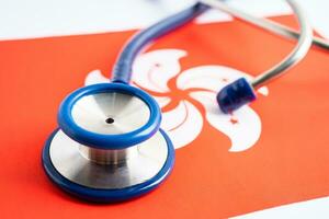 Stethoscope on Hong Kong flag background, Business and finance concept. photo