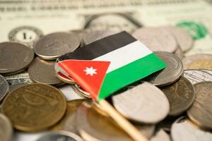 Stack of coins with Jordan flag and US dollar banknotes. photo