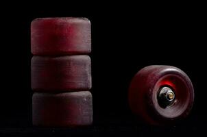 a red skateboard wheel on a black background photo