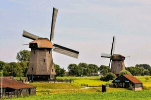 a windmill in the middle of a field photo