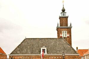 a church with a clock tower in the middle of a town photo