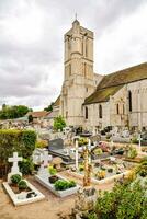 a church with a graveyard in front of it photo