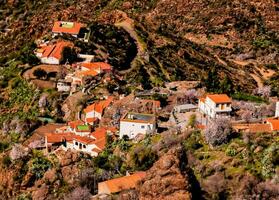 a small village on the side of a mountain photo