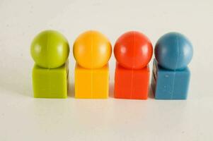 a group of four plastic blocks with different colors photo