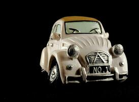 a toy car is shown against a black background photo