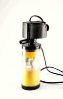 a small portable water filtration machine with a yellow object inside photo