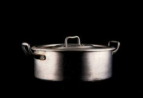 a metal pot on a black background photo