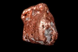 Macro mineral stone of a copper nugget on a microcline on a black background photo