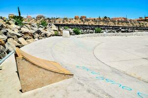 a skateboard ramp in a concrete park photo