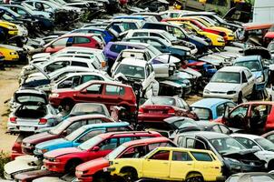 a parking lot full of junk cars in the desert photo